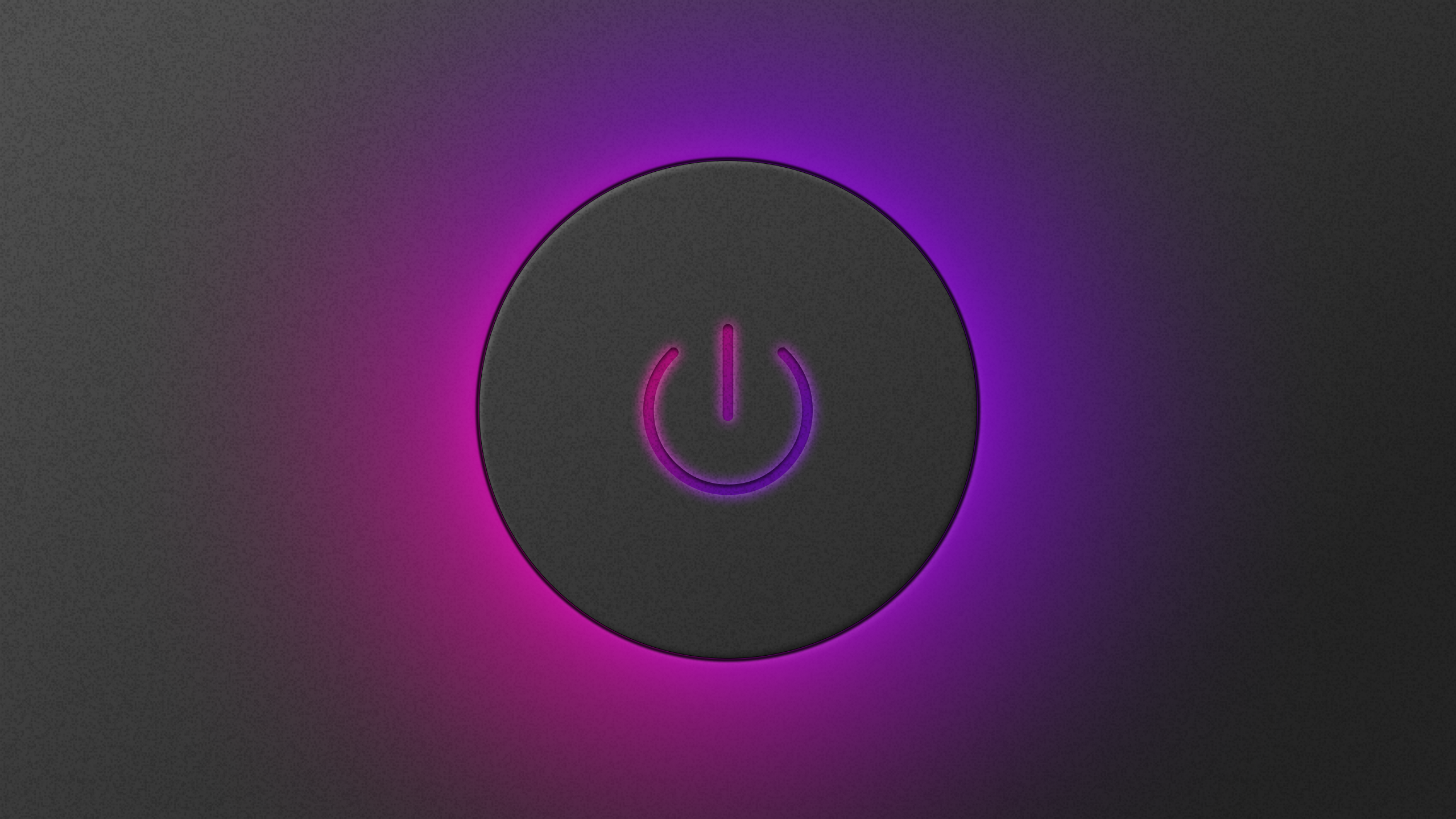 A power button used to turn on a computer, glowing because it has been pressed to turn the computer on.